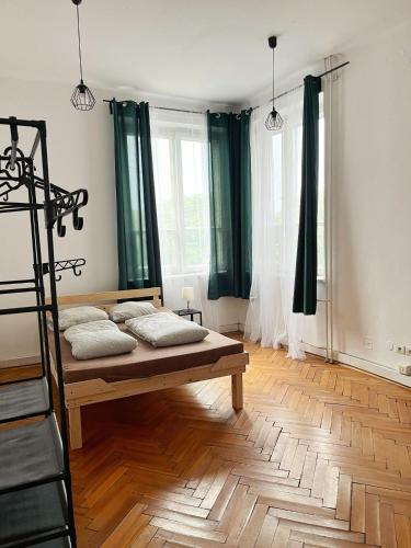 a bedroom with a bed and a wooden floor at Nice View Rooms In Old Town in Krakow