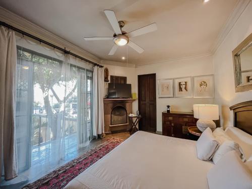 a bedroom with a bed and a large window at Casa Florida B&B in San Miguel de Allende