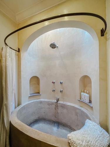 a large bath tub in a bathroom with a sink at Casa Florida in San Miguel de Allende