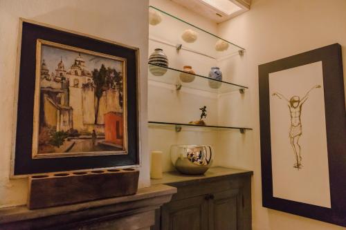 a room with a painting and a picture on the wall at Casa Florida B&B in San Miguel de Allende