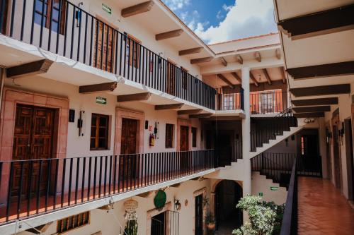 an image of an old building with balconies at Mikaella Hotel in San Miguel de Allende