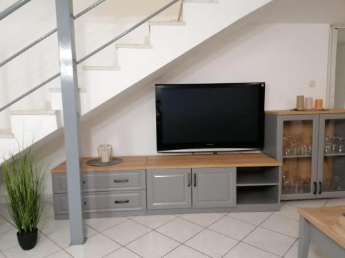 a living room with a flat screen tv on a dresser at Split Ruža Apartment in Split