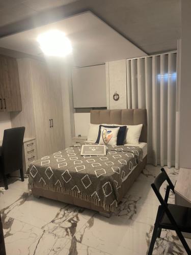 a bedroom with a bed and a desk in it at Sea View Apartment in Patra