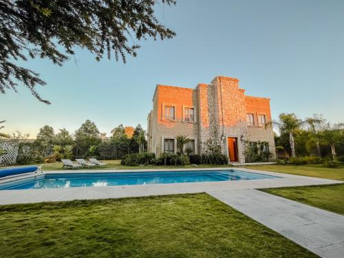 an exterior view of a house with a swimming pool at Hacienda Los Arcangeles in San Miguel de Allende