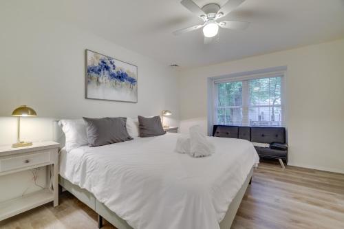 a white bedroom with a bed and a ceiling fan at Chic Penn Estates Home 7 Mi to Camelback Mountain in East Stroudsburg