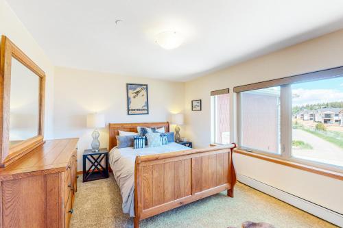 a bedroom with a bed and a large window at WinterStar E-2 in Fraser