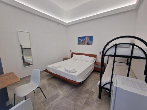 a bedroom with a bunk bed and a chair at b&b sirena camera moderna in Francavilla al Mare