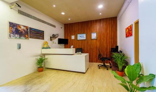 an office with a reception desk and plants at Treebo Golden Swan Tambaram in Tambaram