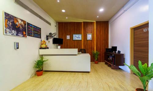 an office with a reception counter and a desk at Treebo Trend Golden Swan Tambaram in Tambaram