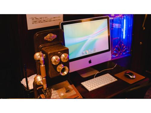 a computer monitor sitting on top of a desk at VAN CORTLANDT HOTEL - Vacation STAY 17472v in Aira