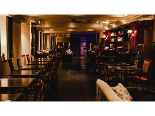 a restaurant with tables and chairs and a bar at VAN CORTLANDT HOTEL - Vacation STAY 17472v in Aira