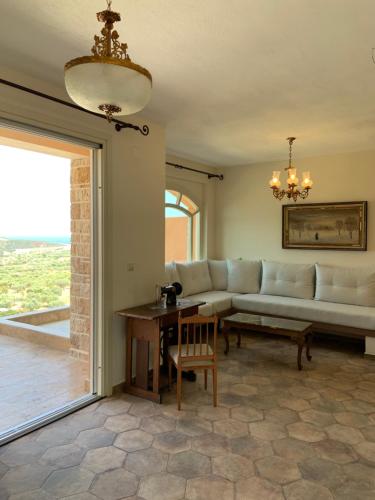 a living room with a couch and a table at ST NIKOLA PANORAMIC SUITES HALKIDIKI in Agios Nikolaos