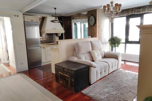 a living room with a white couch and a table at Dxagi-Dxagi in Bermeo