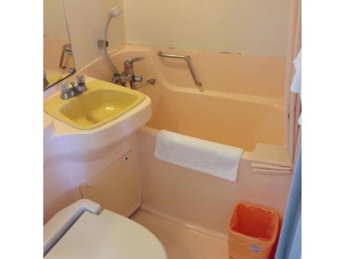 a bathroom with a sink and a toilet and a tub at EN Resort Kumejima EEF Beach Hotel - Vacation STAY 59139v in Kumejima