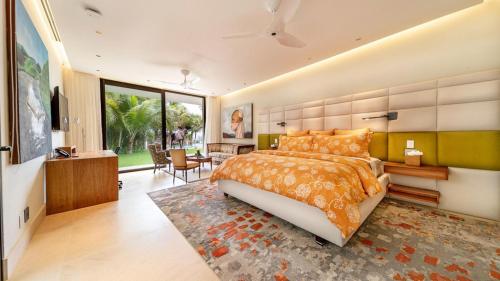 a bedroom with a large bed and a living room at Sunny Vacation Villa no 1 in Bonao