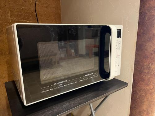 a microwave oven sitting on top of a shelf at Hotel Axia Inn Kushiro - Vacation STAY 67235v in Irifunechō