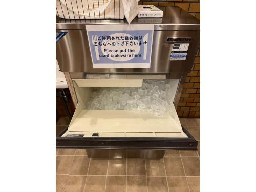 an empty refrigerator in a store with a sign on it at Hotel Axia Inn Kushiro - Vacation STAY 67207v in Irifunechō