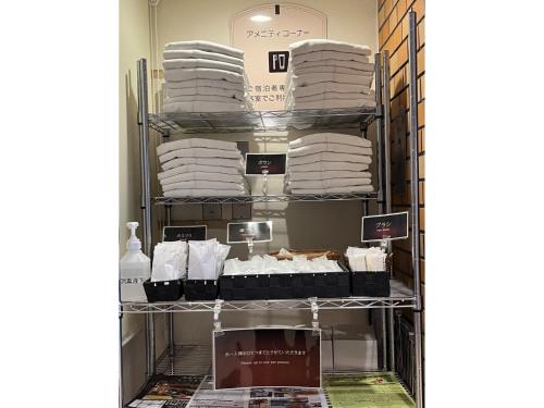 a room filled with white towels on a shelf at Hotel Axia Inn Kushiro - Vacation STAY 67217v in Irifunechō