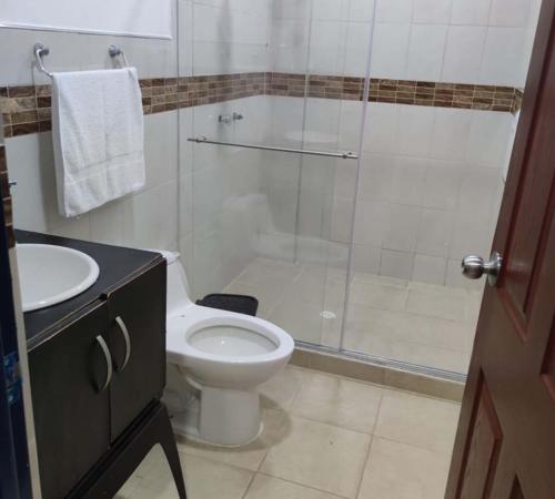 a bathroom with a shower and a toilet and a sink at Finca Hotel Monte del Libano in Montenegro