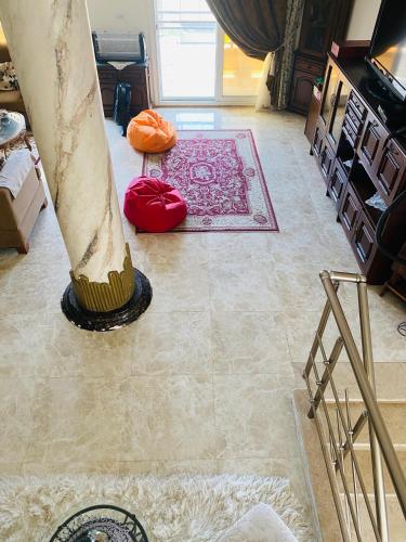 a room with a carpet and a broom on the floor at Lovely Villa 5- bedroom with Overflow Pool with Nice Garden at Green Oasis Resort in Alexandria