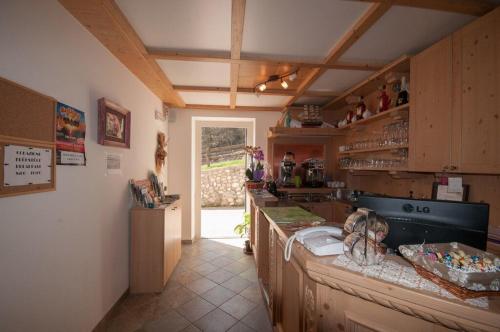 a kitchen with wooden cabinets and a counter top at B&B Ledro AFFITTACAMERE in Mezzolago
