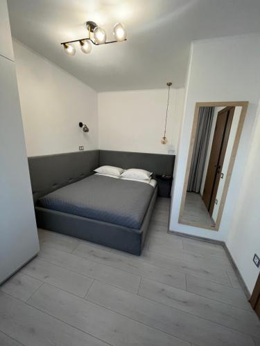 a small bedroom with a bed and a mirror at Гірський Кришталь in Skole