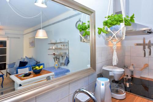 a kitchen with a sink and a mirror at Apartment Pepica in Postira