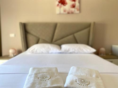 a bedroom with a bed with two towels on it at Fimi Apartments in Ulcinj