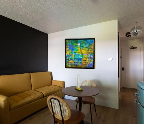 a living room with a couch and a table at Hotel McCoy - Art, Libations, Pool Society in College Station