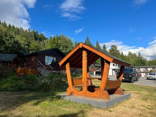 a small wooden structure sitting in the grass at Chalet Inn in Kitimat