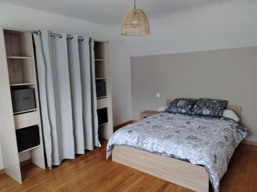 a bedroom with a bed and some white drapes at Maison de campagne avec piscine in Parigny-les-Vaux