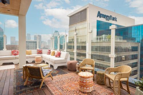 an apartment balcony with furniture and a view of the city at Hôtel Swexan in Dallas
