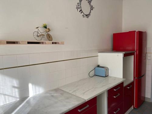 a kitchen with a red refrigerator and a counter at Appartement vieux port in Marseille