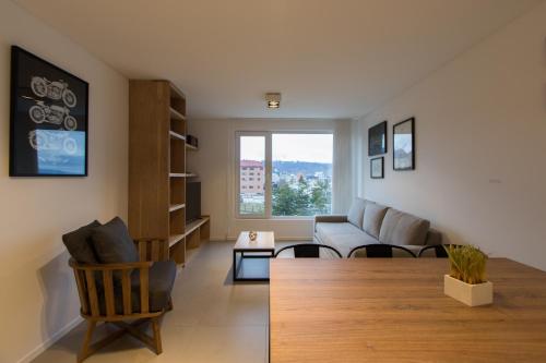 a living room with a couch and a table at Austral Departamentos in Ushuaia