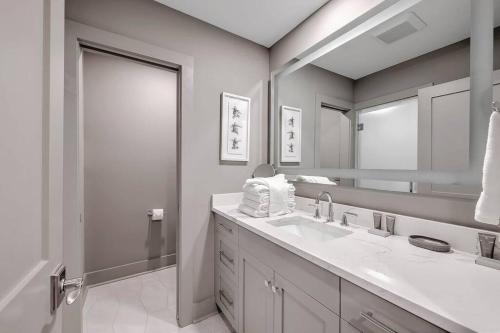 a bathroom with two sinks and a large mirror at New Listing! Seagrove Villa 3A - Luxurious Ocean View! in Isle of Palms