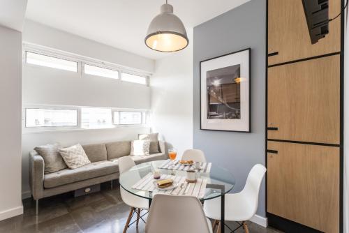 a living room with a table and a couch at Lisbon Airport Suites in Lisbon