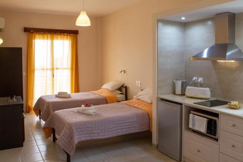 a kitchen with two beds in a room at Kalami Studios in Kalami