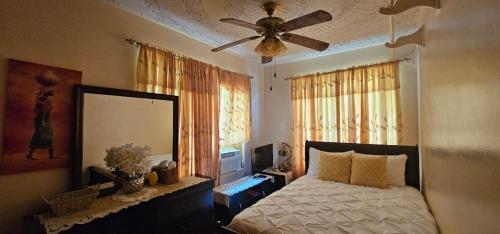 a bedroom with a bed and a ceiling fan at Smitty's Home Away From Home in Charlotte Amalie
