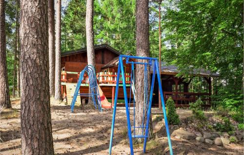 a playground in front of a log cabin at 1 Bedroom Stunning Home In Suleczyno in Sulęczyno