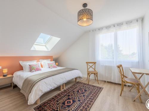 a bedroom with a bed and a table and a window at Gîte Autheuil-en-Valois, 6 pièces, 12 personnes - FR-1-526-39 