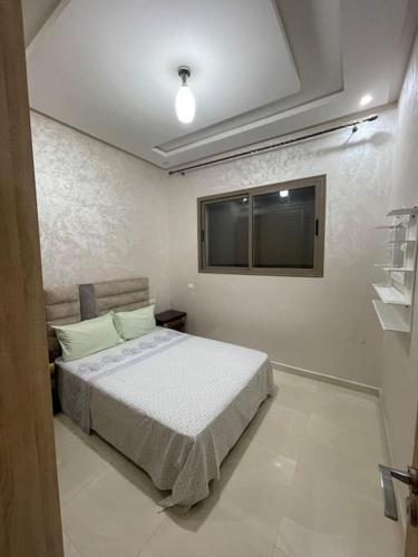 a bedroom with a bed and a window at Bahia beach . Plage dahomey in Bouznika
