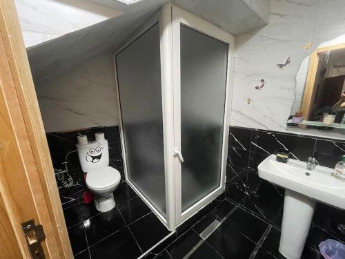 a bathroom with a toilet and a glass shower at Bahia beach . Plage dahomey in Bouznika