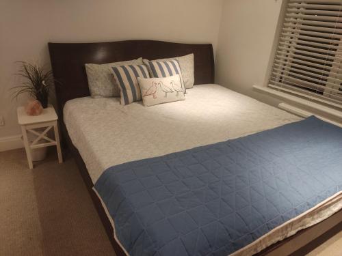 a bedroom with a bed with a blue comforter at Room in private house near Reading University in Earley
