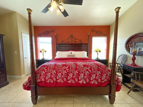 a bedroom with a bed with a red bedspread at The Inn at 37 Main in Rockville