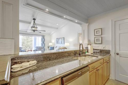 a large kitchen with a sink and a window at Lagoon Villa 22 - Private Villa! Close Walk to Beach! in Isle of Palms