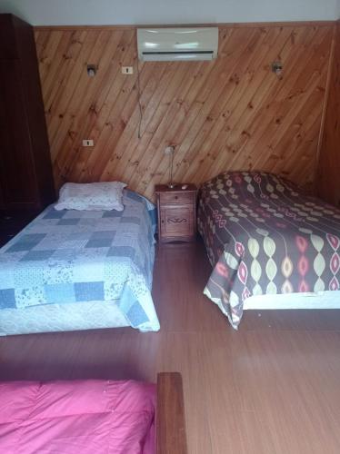 Llit o llits en una habitació de Cabaña con piscina en Curacaví