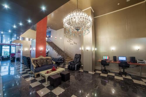 a lobby with a chandelier and a living room at Delphi Art Hotel in Athens