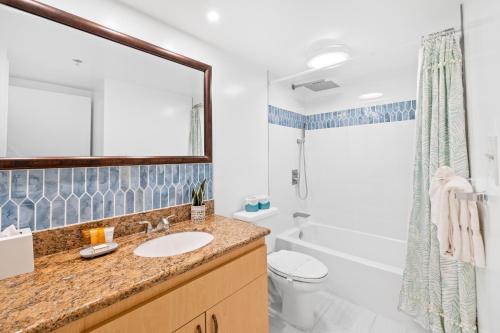 a bathroom with a sink and a toilet and a shower at Stunning Mountain View Condo, Near Beach with Parking in Honolulu