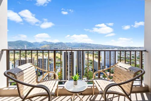 a balcony with two chairs and a table at Stunning Mountain View Condo, Near Beach with Parking in Honolulu