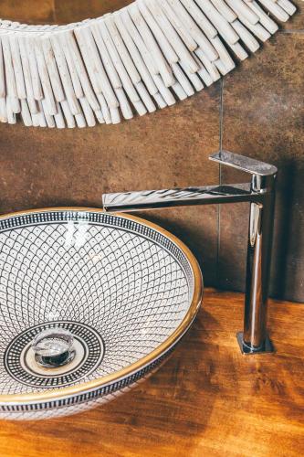 a bathroom sink on a wooden counter with at Eksōtika in Oliveri